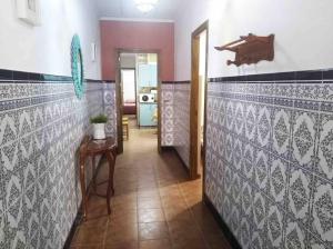 a hallway with blue and white tile on the walls at Casa Galisa in Torrevieja