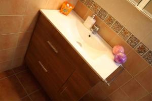 a bathroom with a white sink and a counter at Casa Galisa in Torrevieja +9 photos