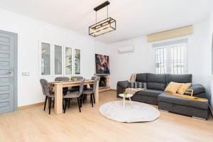 a living room with a couch and a table at Chalet Queen Venecia Sunrise in Campoamor +12 photos