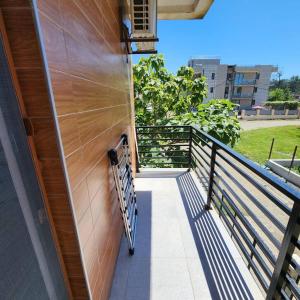 a balcony with a wooden wall and a railing at Rio cottage apartment in Ureki