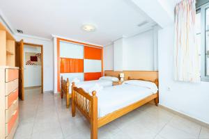 a bedroom with two beds and a window at Maravillas in La Mata +12 photos