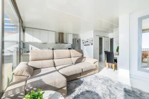 a living room with a couch and a kitchen at Tabarca’s View Santa Pola in Santa Pola +10 photos