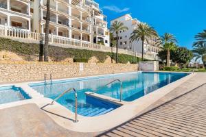 a swimming pool in front of a building at Tabarca’s View Santa Pola in Santa Pola
