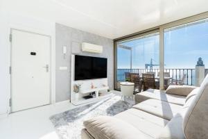 a living room with white furniture and a large window at Tabarca’s View Santa Pola in Santa Pola
