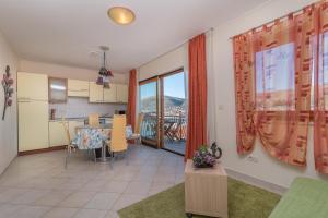 a kitchen and a living room with a table at Villa Bakica in Trogir