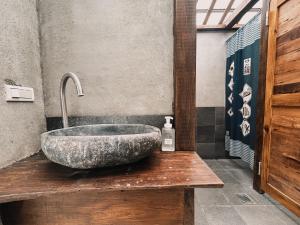a bathroom with a large stone sink on a wooden counter at 楊桃墅民宿 in Chishang +38 photos