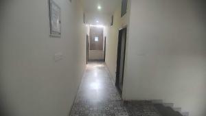 an empty hallway with a hallway leading to a door at HOTEL O STAR INN in Raipur