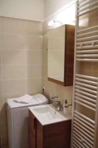 a bathroom with a sink and a washing machine at Treanto Nafpaktos Boutique Hotel in Nafpaktos