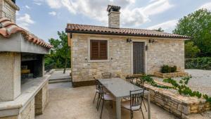 a patio with a table and chairs in front of a building at Villa Zebo by Villas Guide in Barban