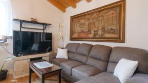 a living room with a couch and a flat screen tv at Villa Zebo by Villas Guide in Barban