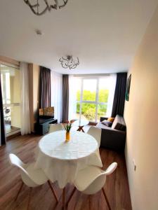 a living room with a white table and chairs at Apartment in Chantrer Residence with garage in Burgas