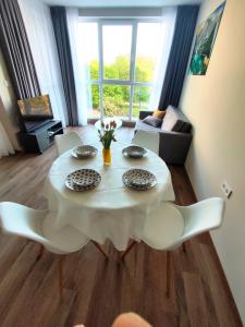 a living room with a white table and chairs at Apartment in Chantrer Residence with garage in Burgas +37 photos