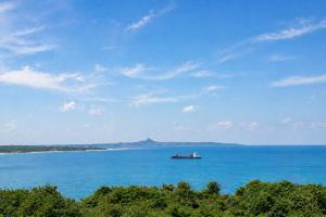 a boat in the middle of a large body of water at simAsim Cottage Kouri in Nakijin