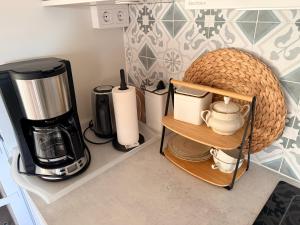 a kitchen with a coffee maker and a coffeemaker at Kinnekulle bed & breakfast in Källby