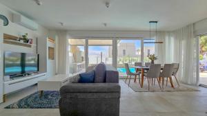 a living room with a couch and a table with chairs at Sea House 1 in Novigrad Istria