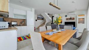 a kitchen and dining room with a wooden table and chairs at Sea House 1 in Novigrad Istria