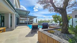 a patio with chairs and a tree on a house at Sea House 1 in Novigrad Istria