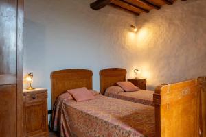 a bedroom with two beds and two night stands at Capanne di Sopra in Torrita di Siena