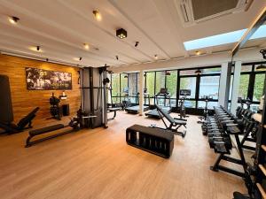 a gym with several treadmills and machines in a room at Boutique-Hotel Bayerischer Hof in Kempten