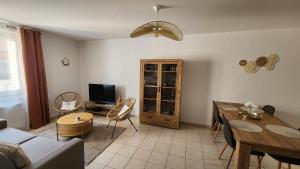 a living room with a couch and a table at Le petit marché de Sainte Cécile- Centre historique Albi in Albi