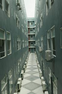 an empty hallway of an apartment building with windows at Le Srivaree Suvarnabhumi Airport Hotel in Samutprakarn