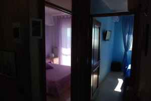 Postel nebo postele na pokoji v ubytování B&B LA BAIA Sea Rooms