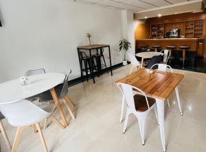 a dining room with white tables and white chairs at Rosabel in Benidorm