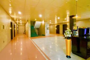a hallway of a building with a vase of flowers at FabHotel Ace Prime in Greater Noida