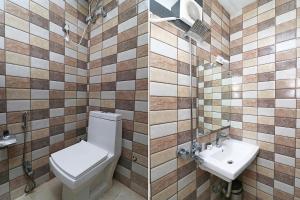 a bathroom with a toilet and a sink at FabHotel Ace Prime in Greater Noida +25 photos