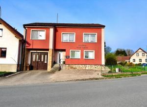 a red house on the side of a street at Apartmán Dolní Němčice in Dačice