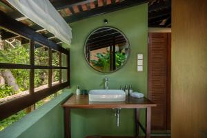 a bathroom with a sink and a mirror at Sama Retreats - Kosgoda in Kosgoda