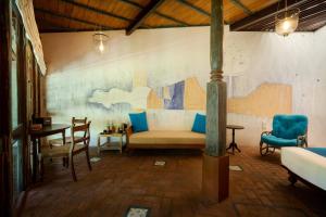a living room with a couch and a table at Sama Retreats - Kosgoda in Kosgoda