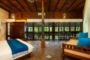 a bedroom with a bed and a dining room at Sama Retreats - Kosgoda in Kosgoda