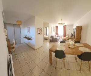 a dining room and living room with a table and chairs at Le petit marché de Sainte Cécile- Centre historique Albi in Albi