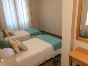 Postel nebo postele na pokoji v ubytování Apartamentos Sousa