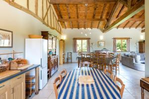 a kitchen and dining room with a table and chairs at La Jouanhitte in Bourrouillan