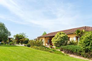 a house with a lawn in front of it at La Jouanhitte in Bourrouillan