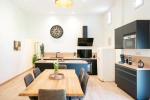a kitchen and dining room with a wooden table and chairs at Gite de Laluby in Arx