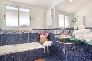 a bathroom with a tub and a sink and a bath tub at Duplex Beach Masnou in El Masnou +22 photos