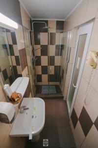 a bathroom with a sink and a shower at Hotel Sunset Beach Vama Veche in Vama Veche +24 photos