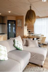 a living room with two white couches and a table at Boho Shale in Yablunytsya