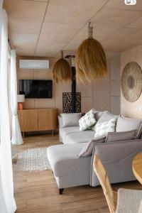 a living room with two couches and a tv at Boho Shale in Yablunytsya