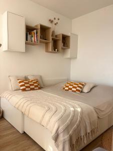a bedroom with a large bed with white walls at À 1min à pied de la mer, studio lumineux & cosy in Carnon-Plage