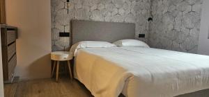 a bedroom with a large white bed with a wall at Hotel Piuro in Prosto di Piuro +116 photos