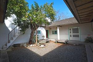 a house with a tree and a bench in the yard at 楊桃墅民宿 in Chishang