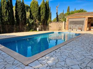 a swimming pool in a yard with trees at Château Borie Neuve in Badens