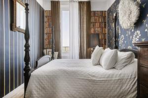 a bedroom with a bed with white pillows at Alombre in Lectoure