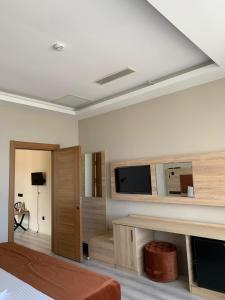 a living room with a flat screen tv on a wall at Mitra Black Sea in Arhavi
