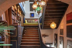 a spiral staircase in a building with a couch on it at Alombre in Lectoure