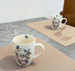 two coffee cups sitting on top of a table at Diving Apartments in Molunat +29 photos
